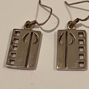 Silver drop earrings with square and tree shaped cut out.